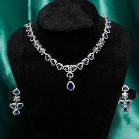 Jewelry set with necklace and earrings on a black mannequin against a green background