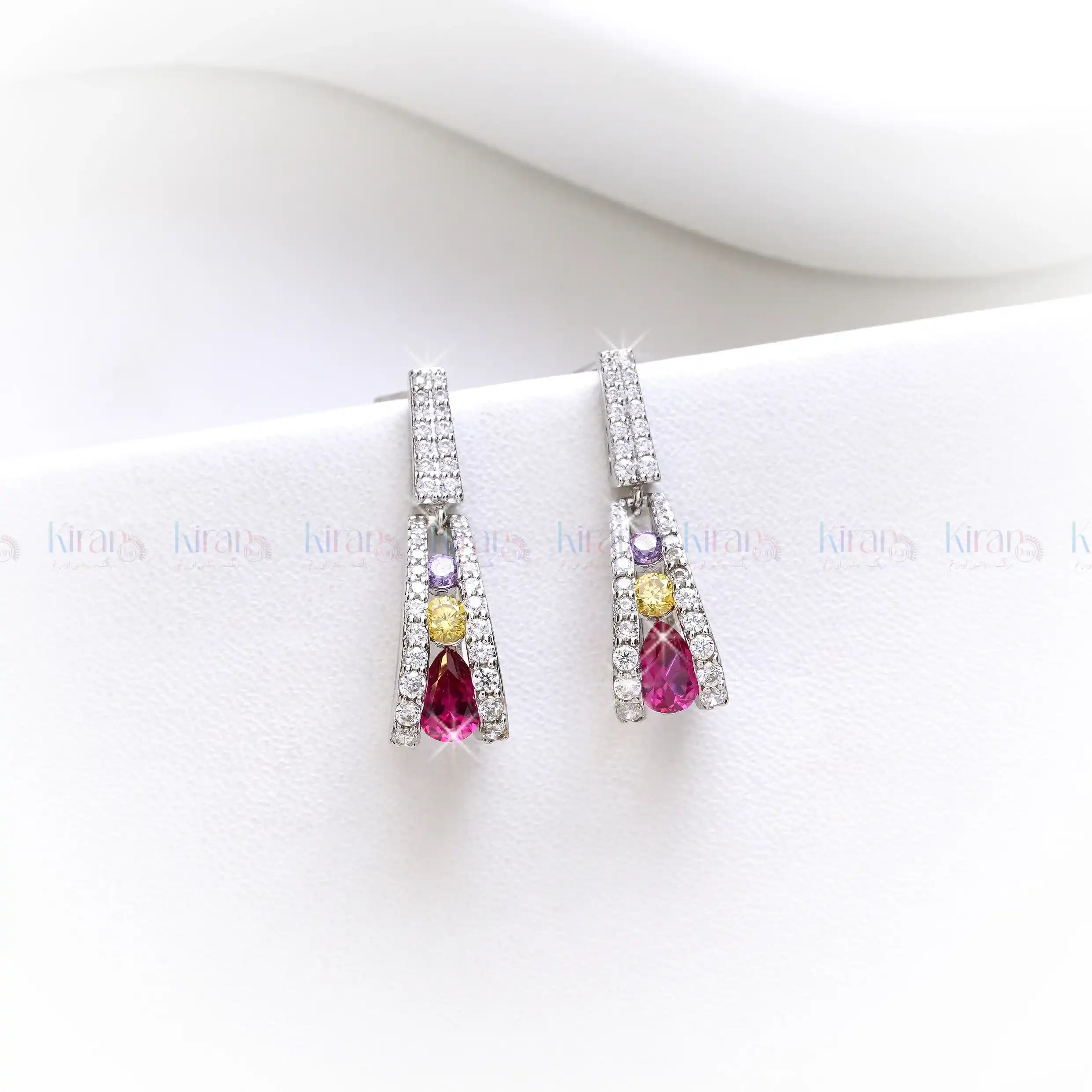 Pair of earrings with gemstones on a white background
