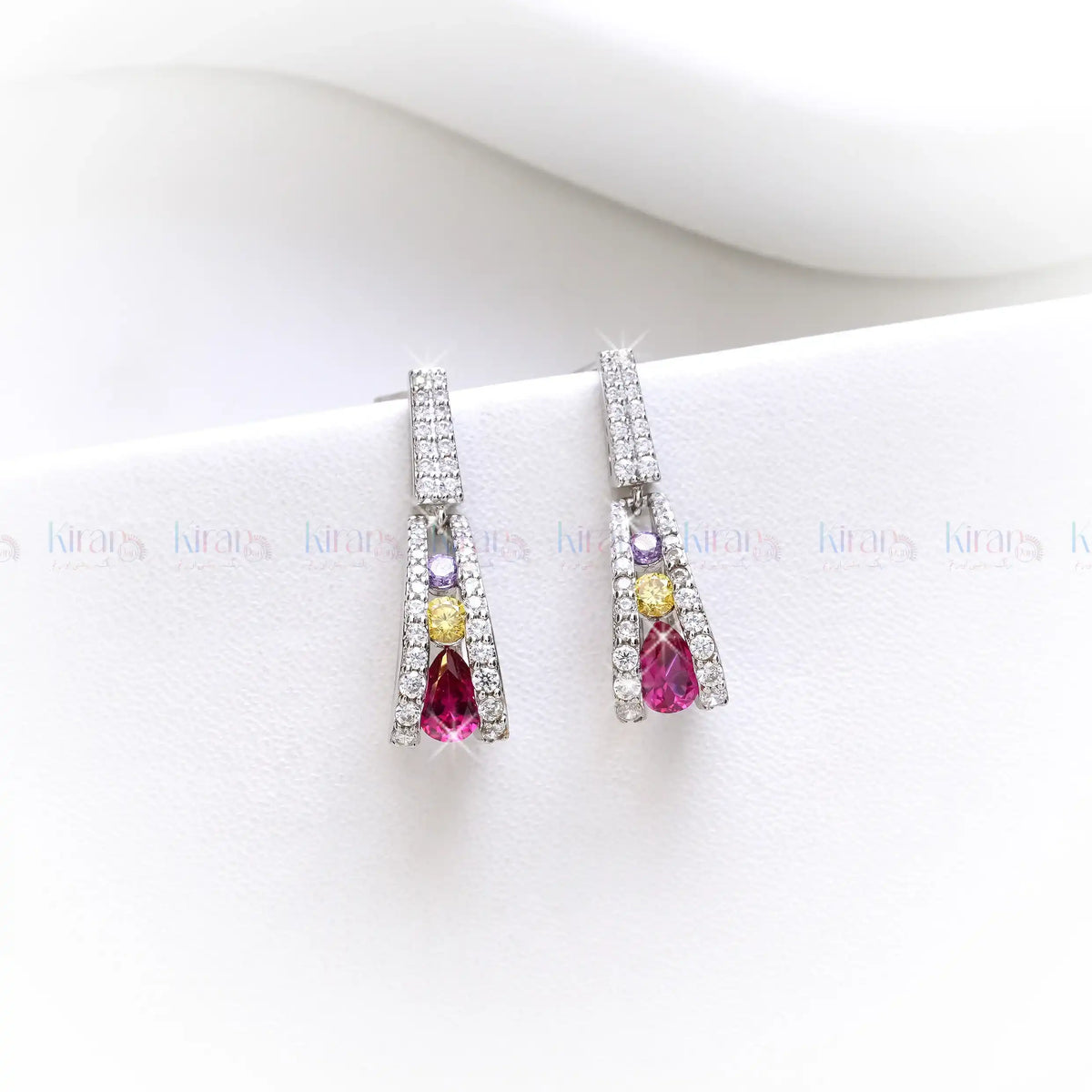 Pair of earrings with gemstones on a white background