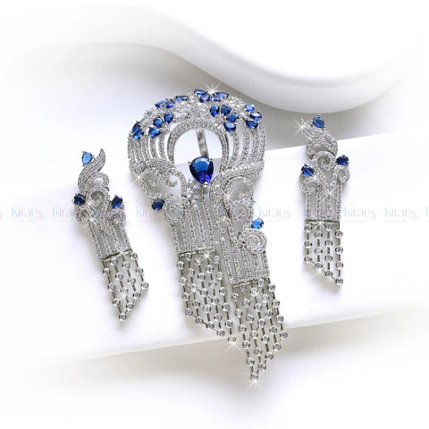 Pair of earrings with red gemstones and clear crystal elements on a white background