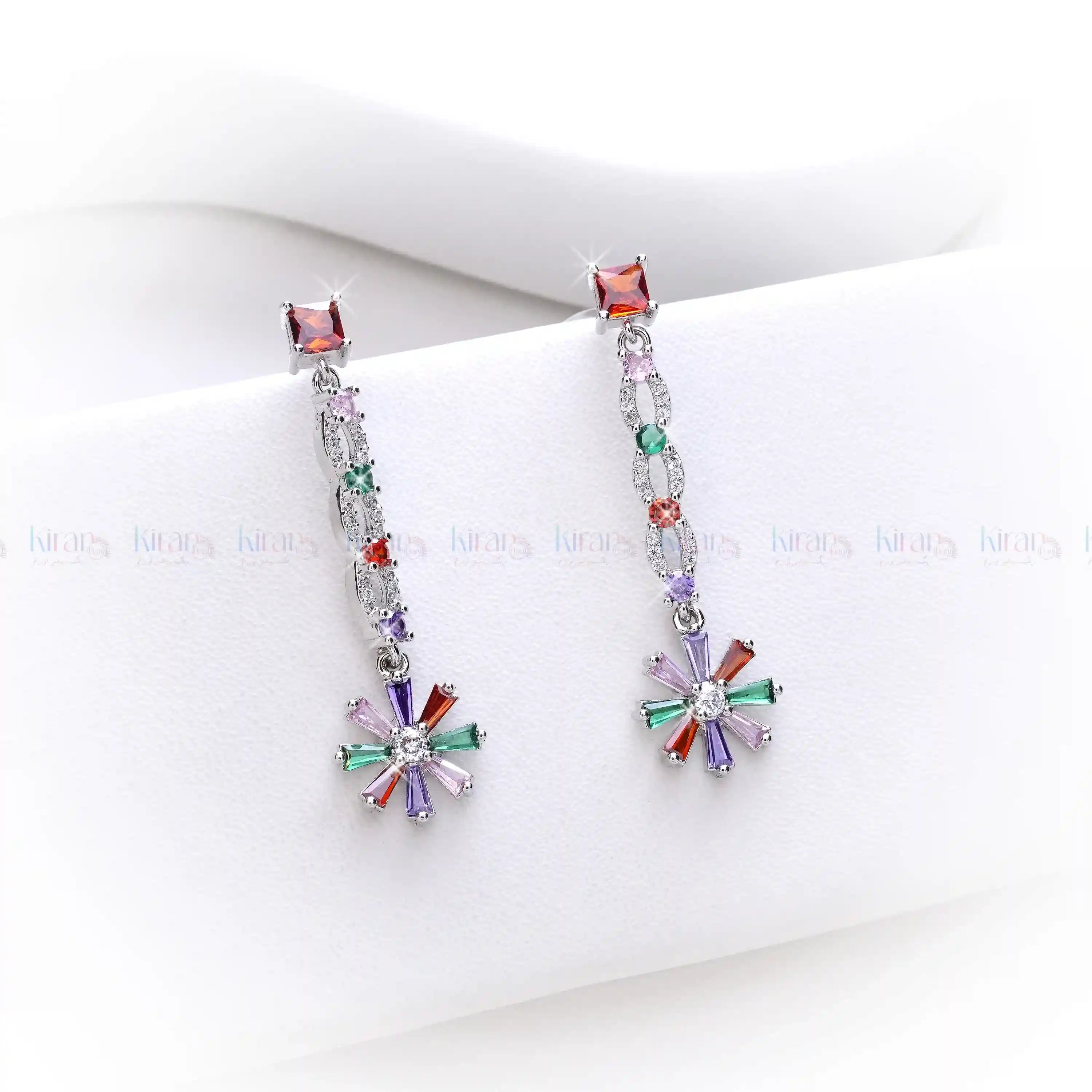Multicolored beaded earrings on a white surface