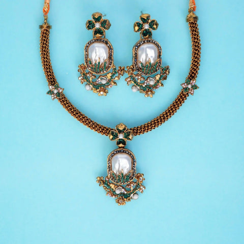 Jewelry set with necklace and earrings on a light blue background
