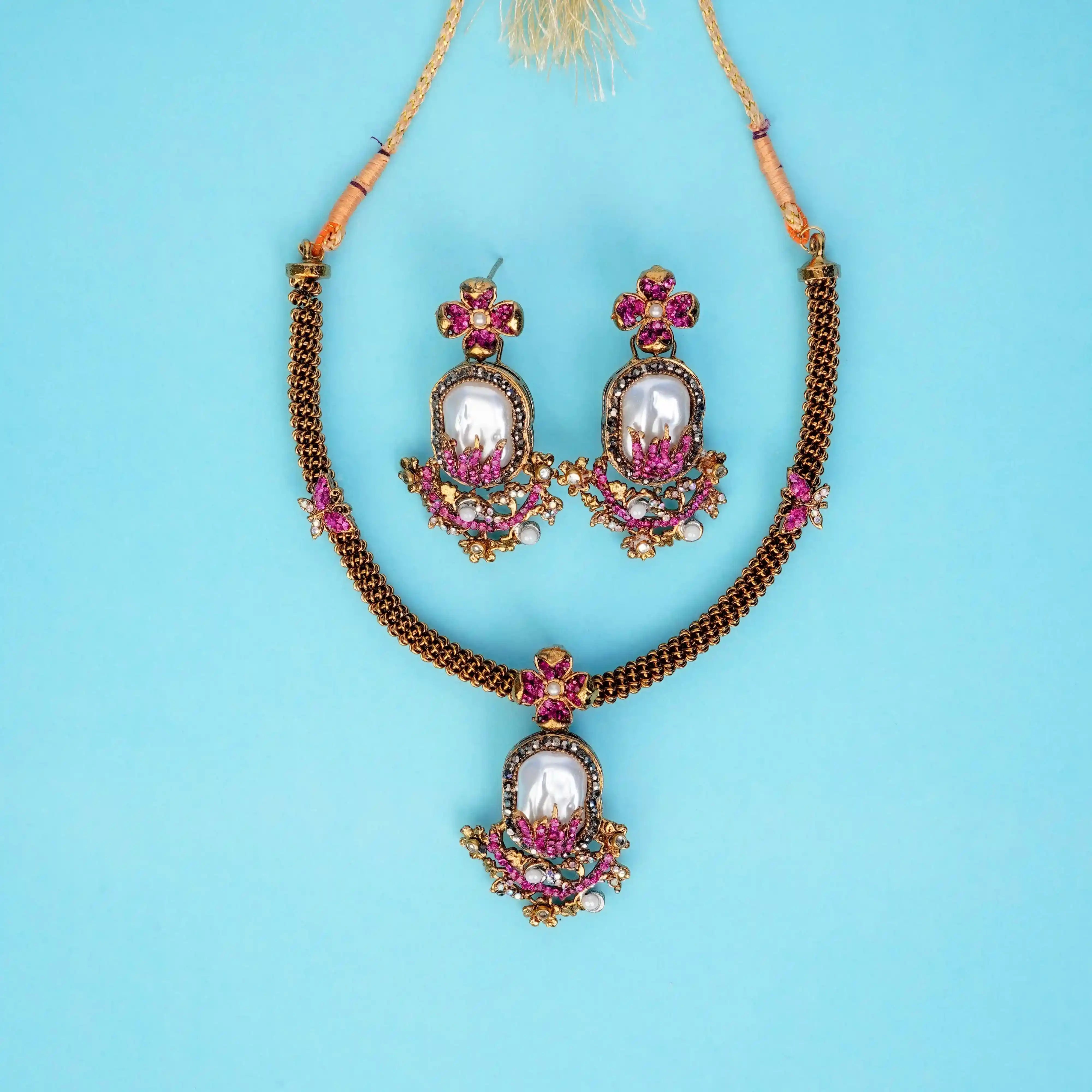Jewelry set with necklace and earrings on a blue background