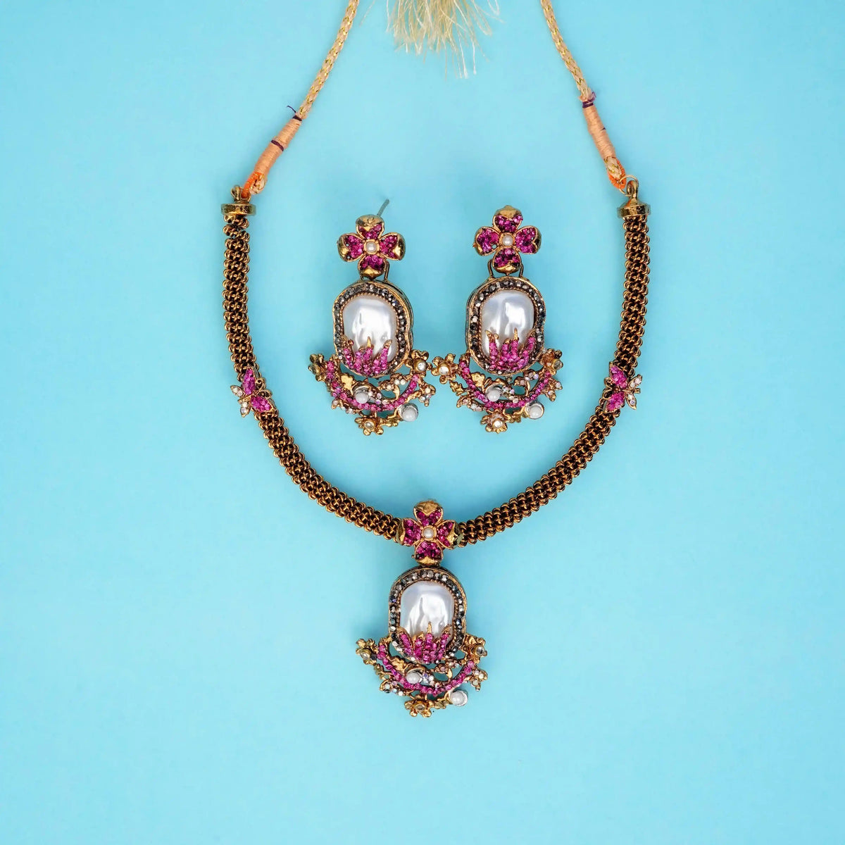 Jewelry set with necklace and earrings on a blue background