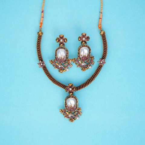 Jewelry set with necklace and earrings on a blue background
