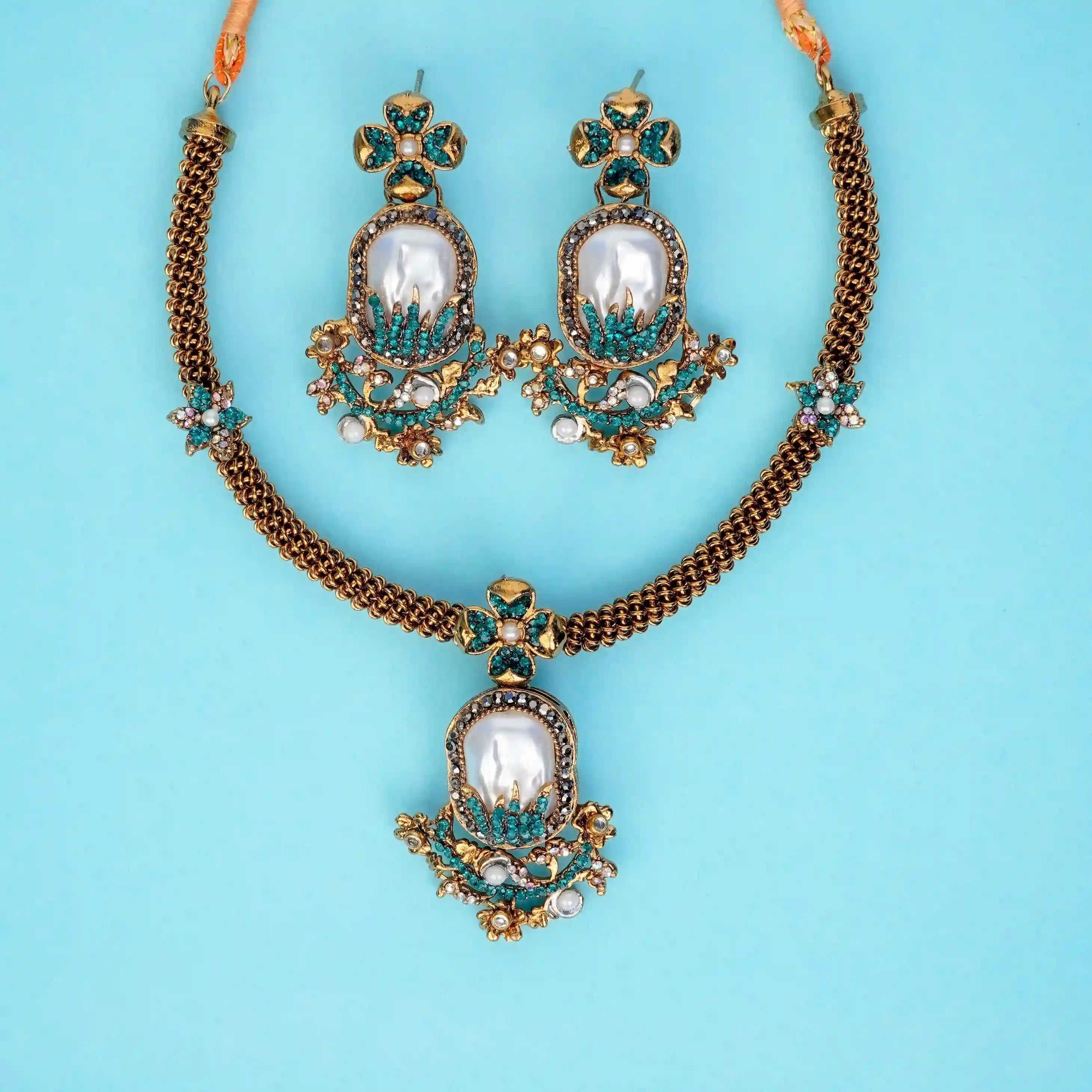 Jewelry set with necklace and earrings on a light blue background