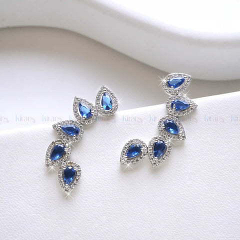 Pair of blue teardrop earrings on a white background