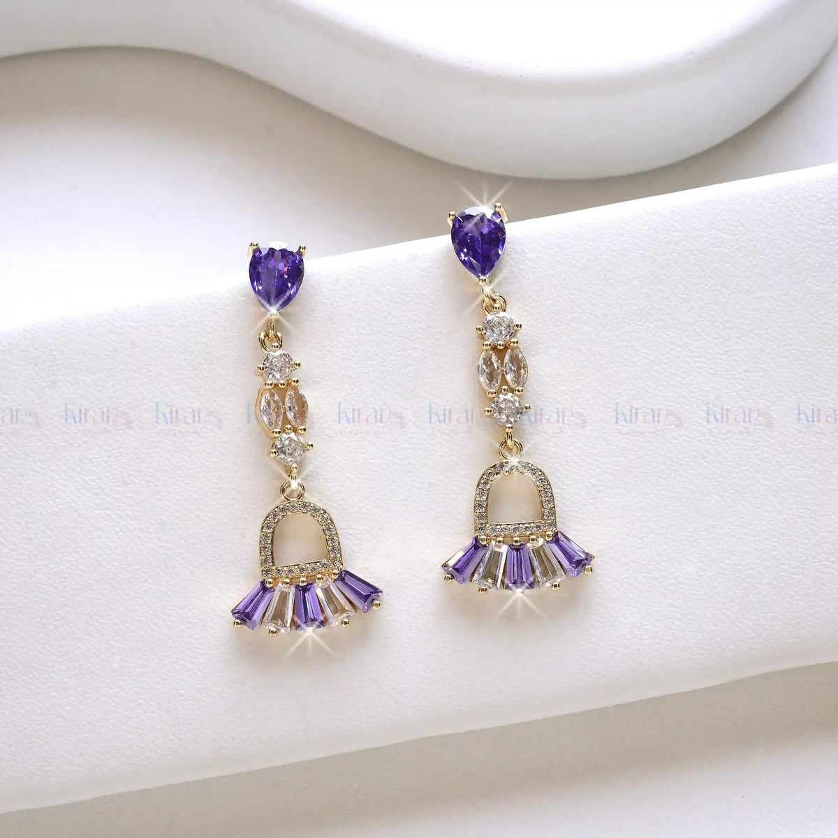 Purple gemstone earrings on a white background
